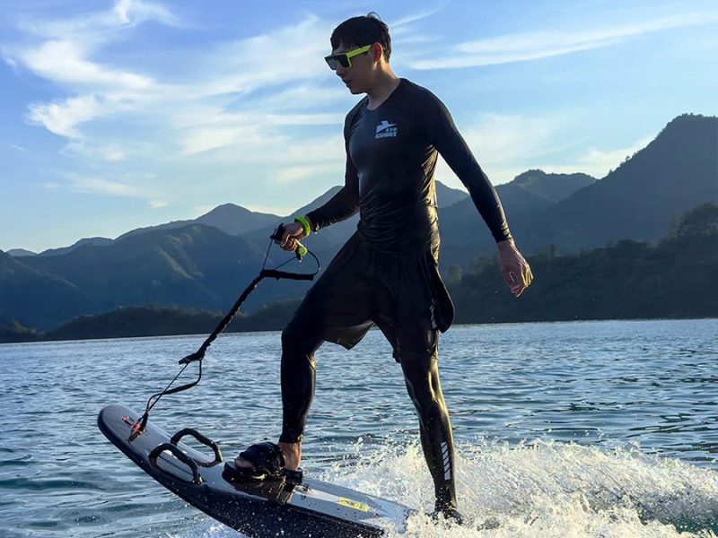 a man standing next to a body of water